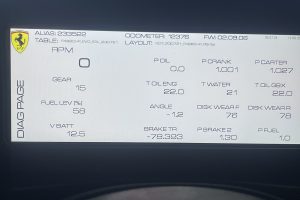 IMG_4465 – Sage Auto Sport Ferrari-branded car diagnostic screen showing engine RPM at zero and multiple telemetry readouts (gear, fuel, oil, and crank values).