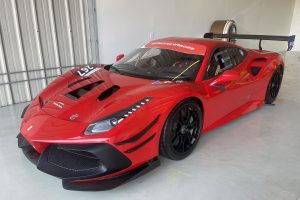IMG_4470 – Sage Auto Sport Red Ferrari race car inside a garage, front and large rear wing visible.